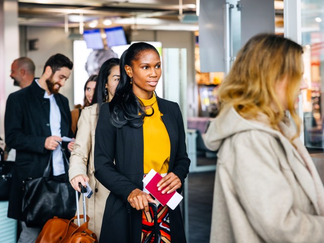 Passengers waiting in line to board airplane