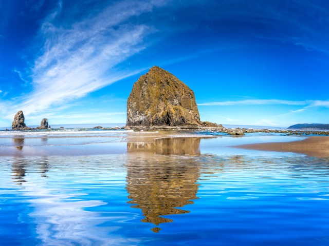 Haystack Rock off Cannon Beach, Oregon, with reflection in water