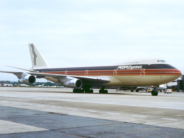 People Express Boeing 747 taxiing at airport