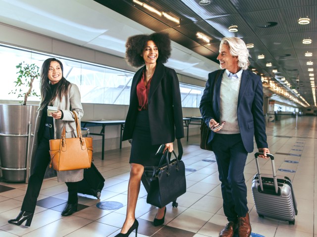 Travelers in airport with luggage