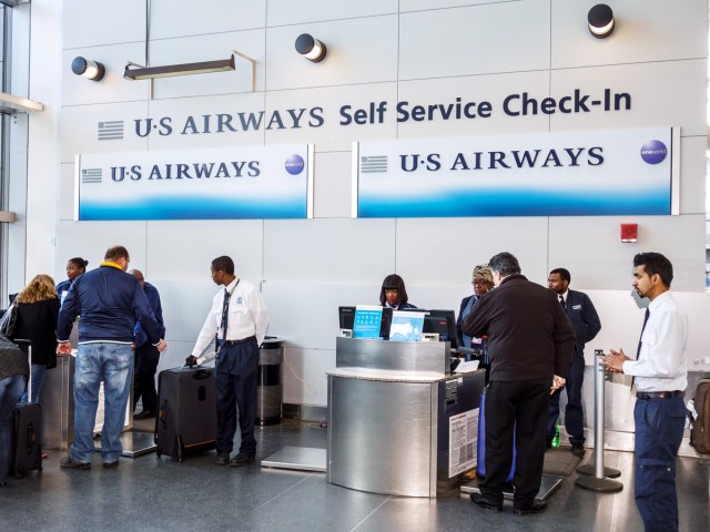 Passengers and employees at US Airways check-in counter