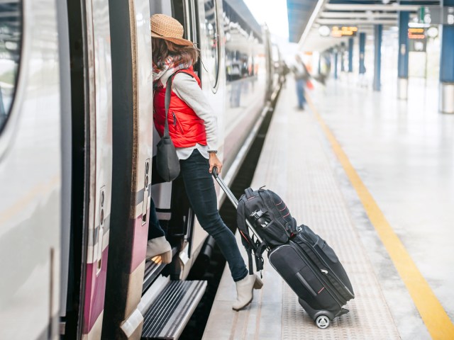 Passenger boarding train with luggage