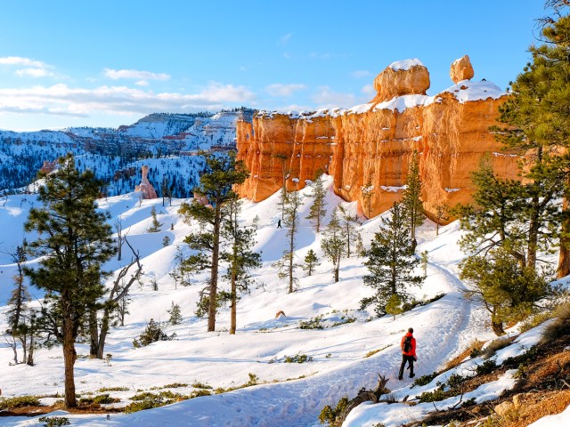 Hiker on snowy trail in Bryce Canyon National Park, Utah