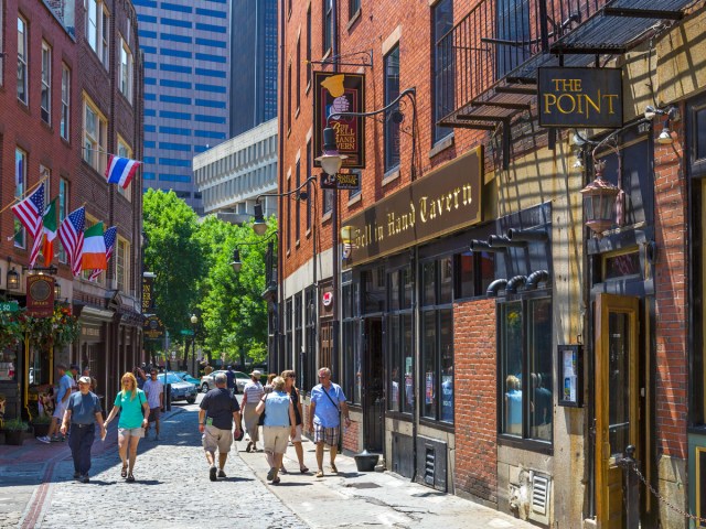 Pedestrians outside of Bell in Hand Tavern in Boston, Massachusetts