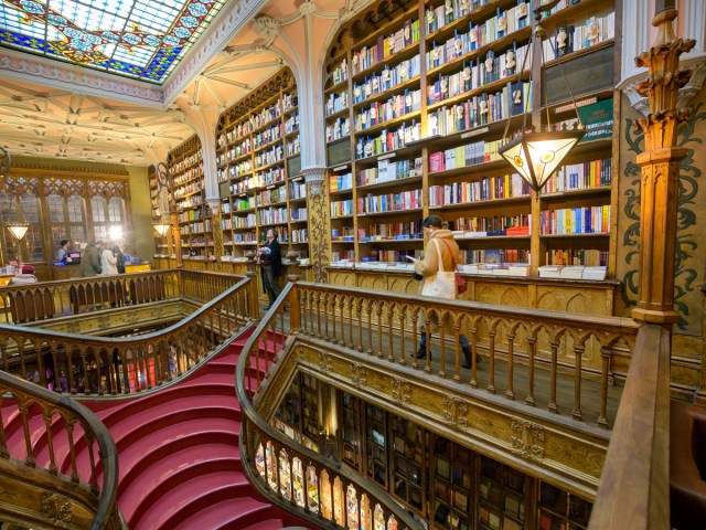 Shoppers inside light-filled space at Livraria Lello in Porto, Portugal