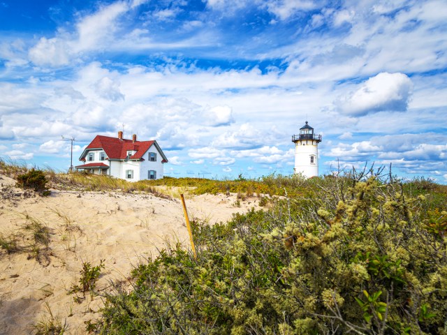 Lighthouse and house along sandy bluffs of Cape Cod, Massachusetts