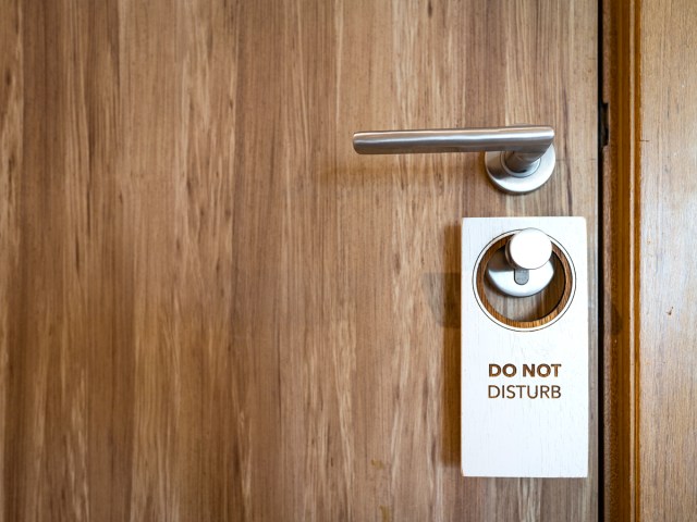 "Do not disturb" sign on hotel room door handle