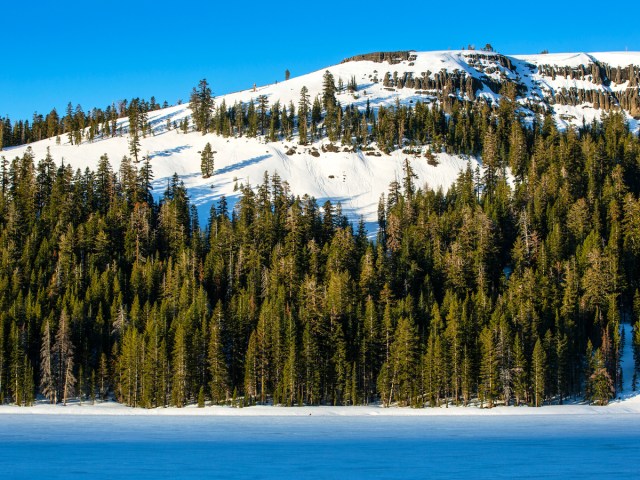 Snowy Kirkwood Mountain next to lake in Northern California