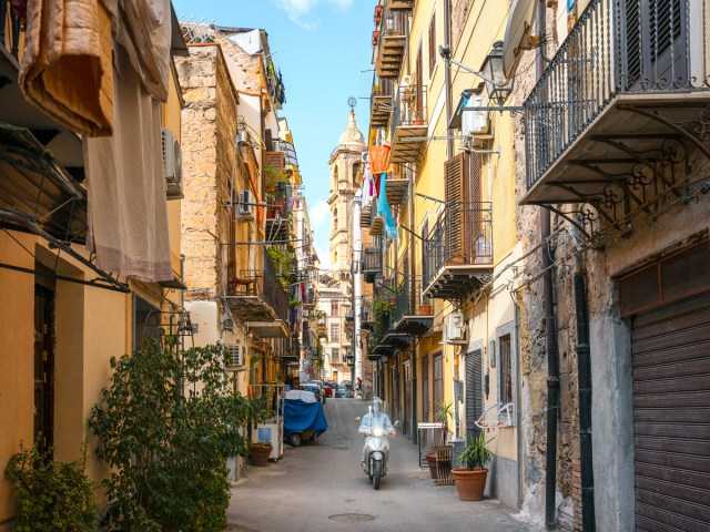 Vespa on narrow street in Palermo, Italy