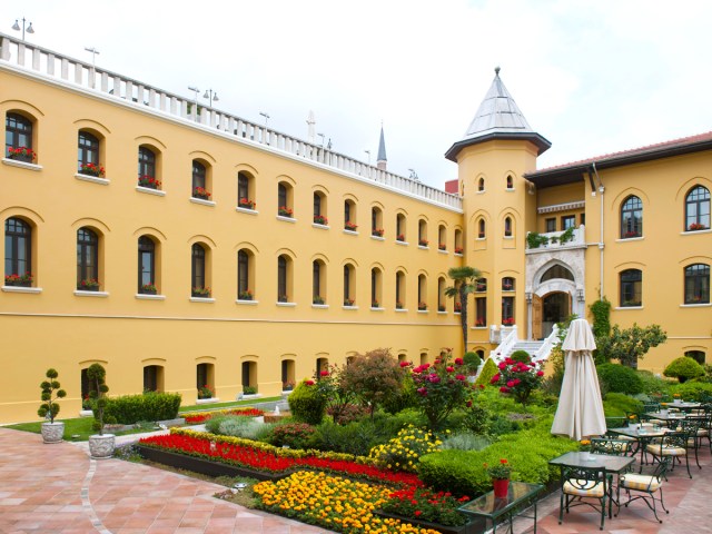 Courtyard and brightly painted exterior walls of the Four Seasons Hotel Istanbul at Sultanahmet 