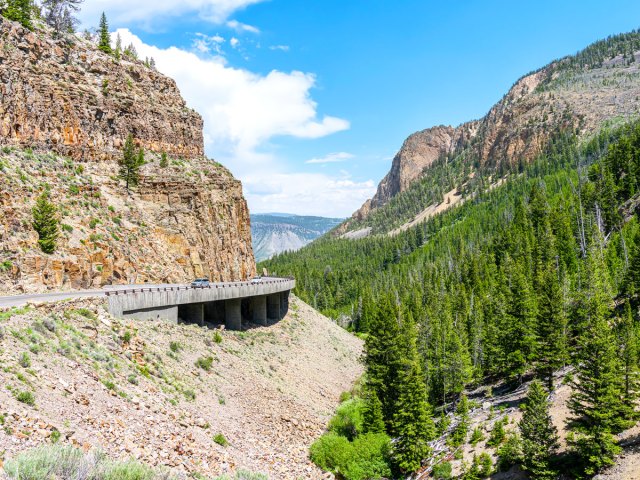 Car on mountainside road in Yellowstone National Park