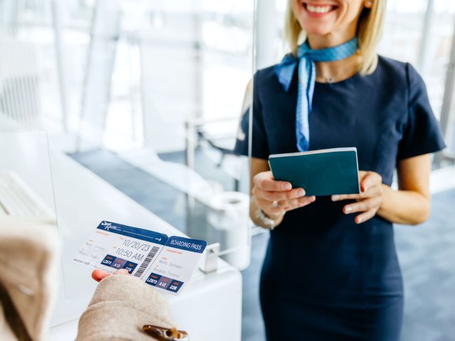 Airport employee checking a passenger's documents