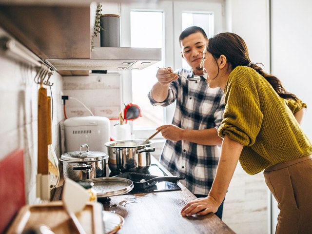 Couple cooking together in kitchen