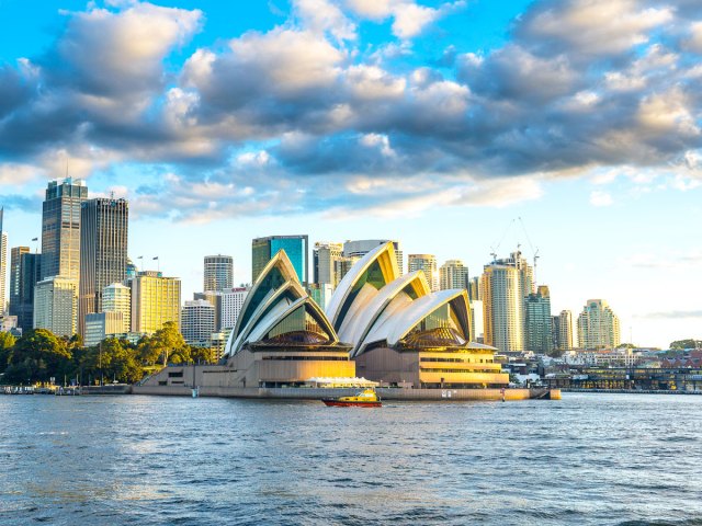 Sydney Opera House alongside Sydney Harbour and skyline