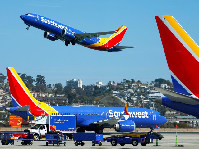 Southwest Airlines Boeing 737 taking off as another taxies by
