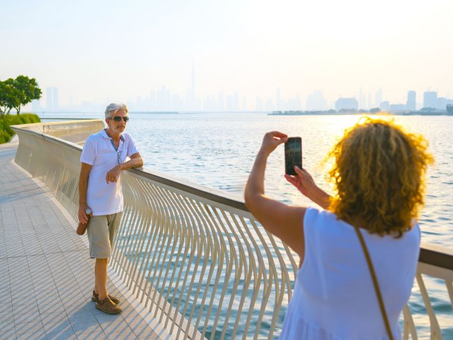 Couple taking photo along water
