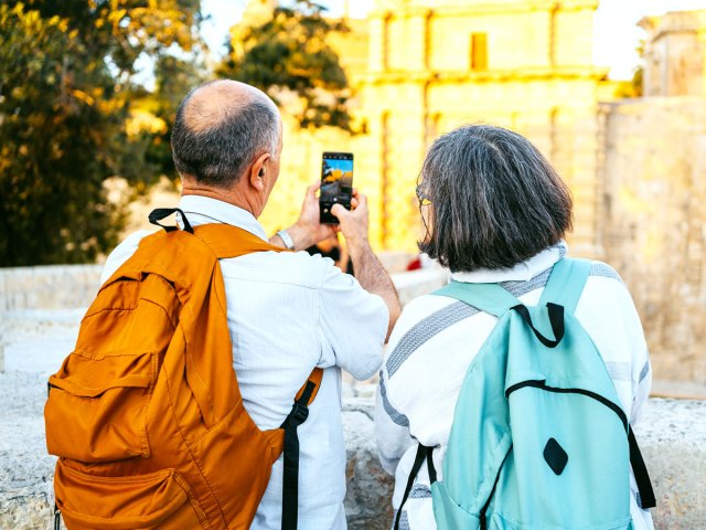 Tourists taking photo of Mdina Gate in Malta