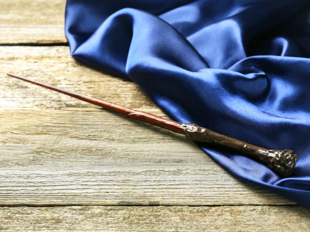 A toy wand sitting on a wooden table