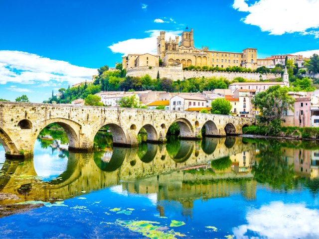 Historic bridge and hilltop cathedral in Beziers, France