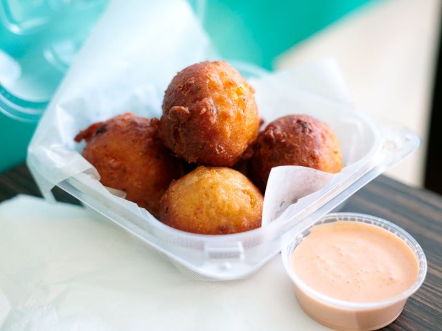 Basket of conch fritters with dipping sauce