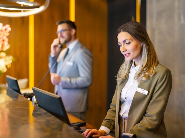 Employees working at hotel front desk