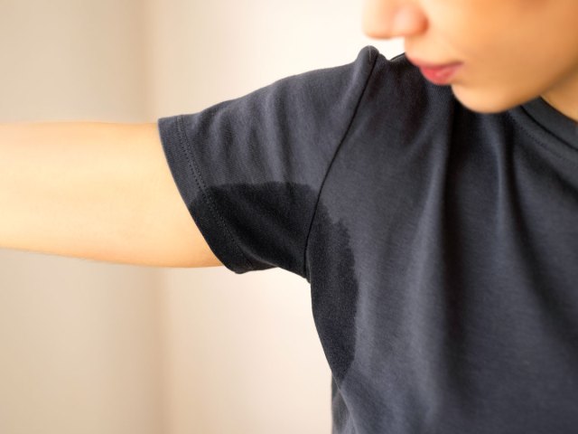 Person with underarm sweat stain