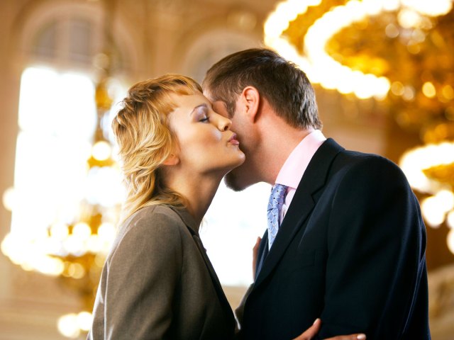 Two people greeting with kiss on cheek