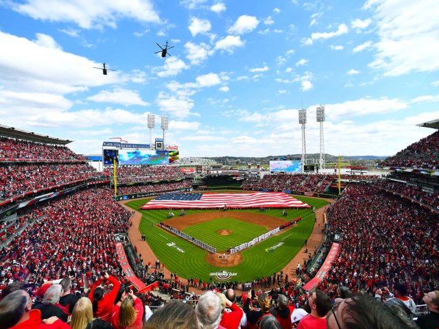Helicopters flying American flag draped on outfield of Great American Ballpark in Cincinnati, Ohio