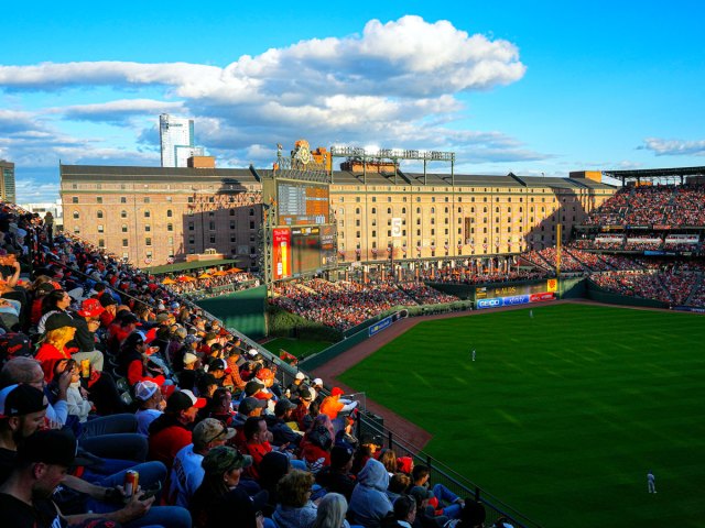 Fans watching game at sunset at Oriole Park in Baltimore, Maryland