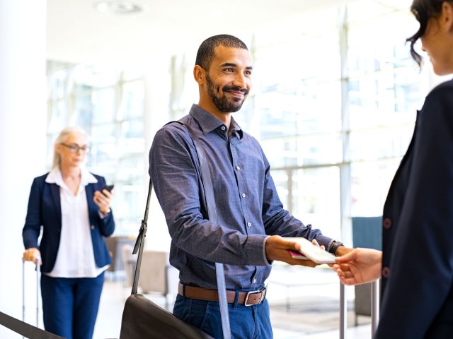 Passenger showing boarding pass to gate agent