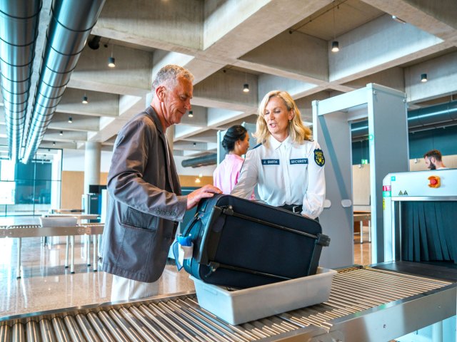 Passenger passing through airport security checkpoint