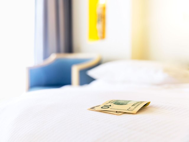 $10 bill on a hotel bed