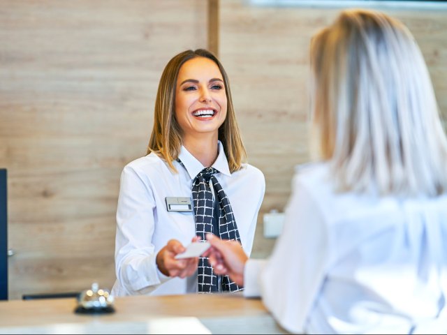 Interaction between front desk employee and hotel guest