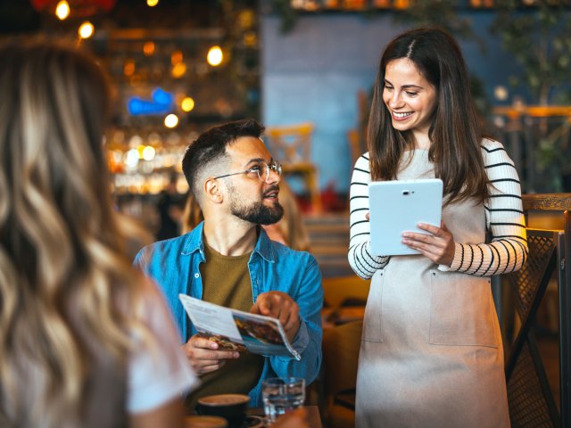 Diners ordering at restaurant