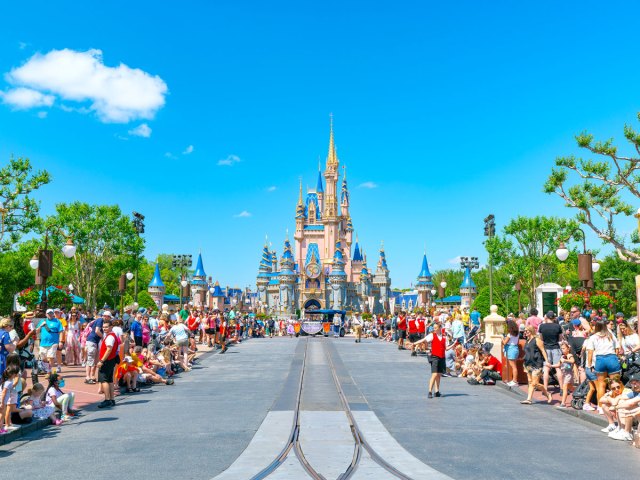Crowds form along parade route toward Cinderella's Castle at Walt Disney World in Florida
