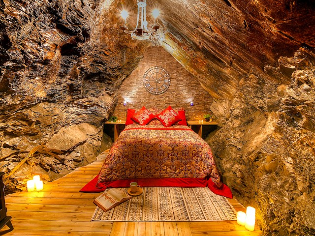 Bed inside cave room at Deep Sleep in Wales