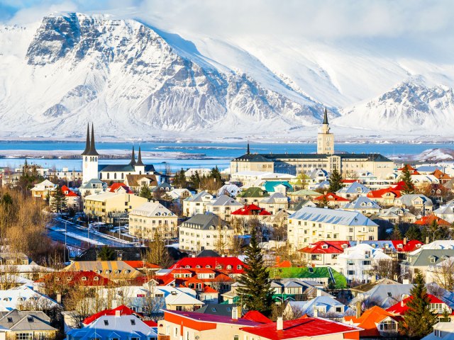 Aerial view of Reykjavik, Iceland, with snow-covered mountains in background