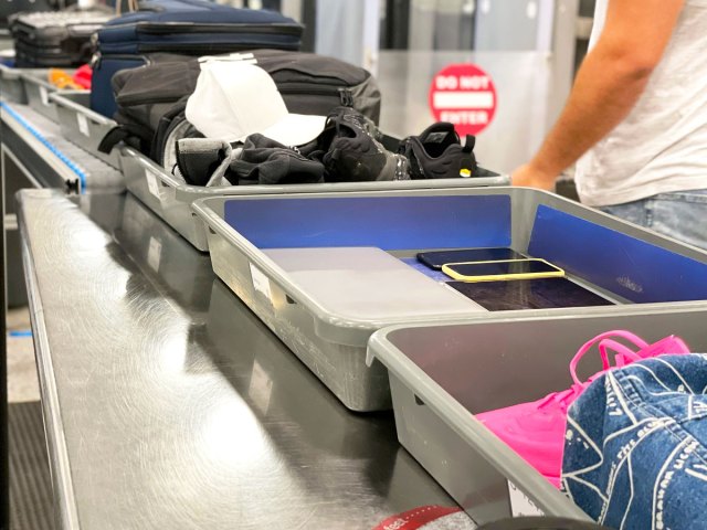 Bins filled with travelers' items at TSA security checkpoint