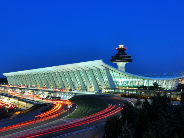 Main terminal building and control tower at Washington Dulles International Airport illuminated at night