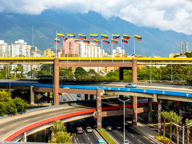 Venezuelan flags flying over highway interchange in Caracas
