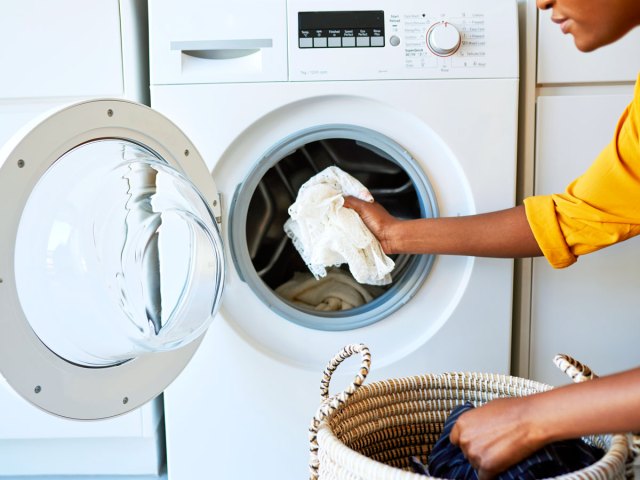 Person loading washing machine