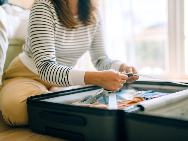Person packing suitcase