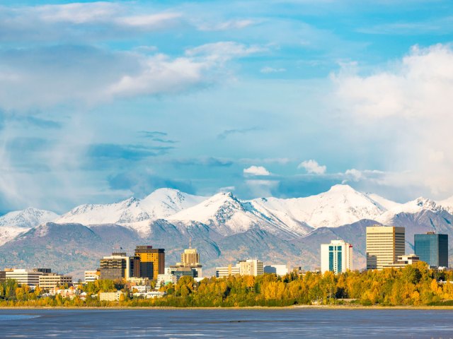 Anchorage cityscape against snowy mountain backdrop