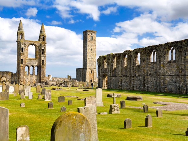 Gravestones with church ruins at St. Andrews Cathedral Cemetery in Scotland