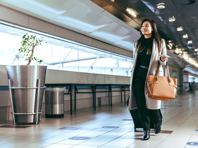 Passenger walking by check-in counter at airport