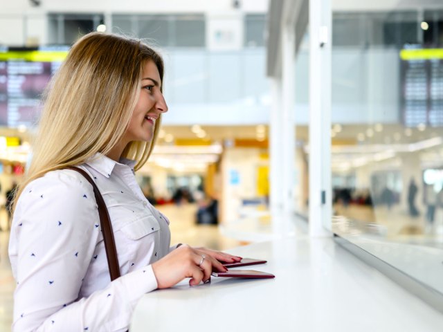 Passenger speaking with ticketing agent at airport