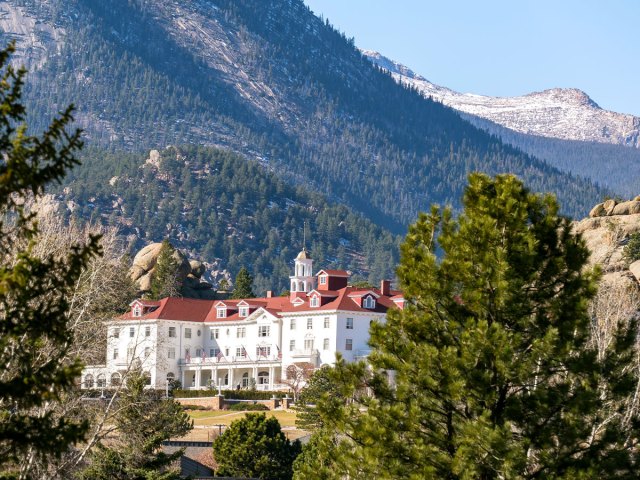 View of Stanley Hotel and mountains in distance in Estes Park, Colorado