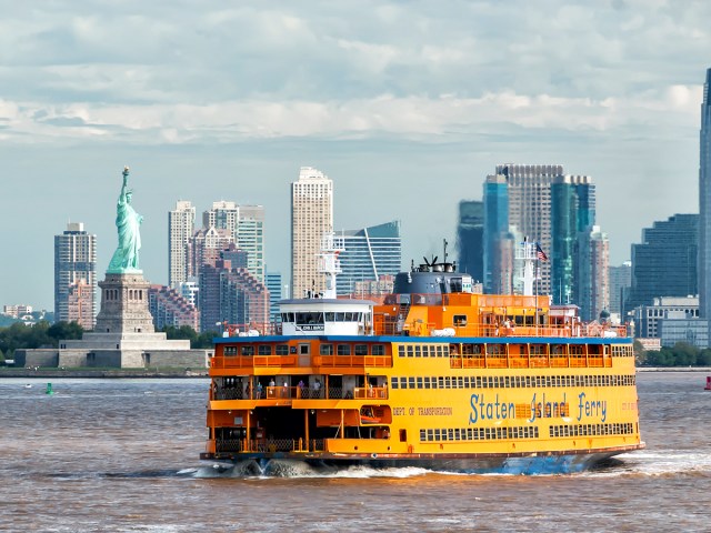 Staten Island Ferry sailing past Statue of Liberty